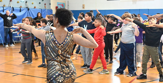 Students dancing with a member of the  Phyllis Rose Dance Company 