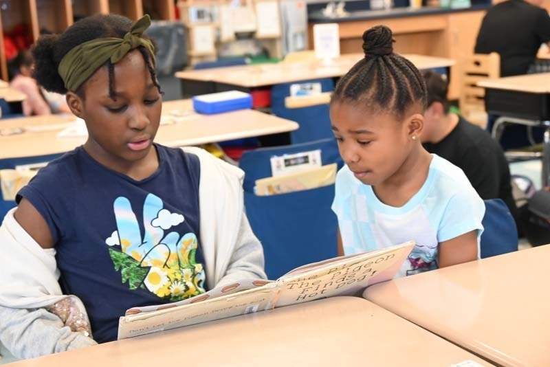 Student Reading to another student