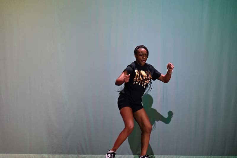 A student dancing on a stage