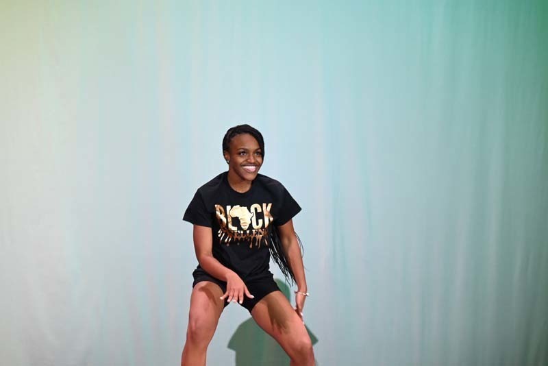 A student dancing on a stage