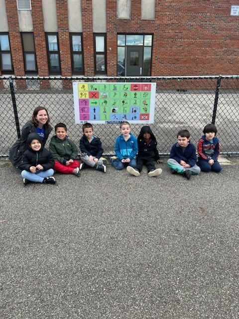 Students outside with Communication Board