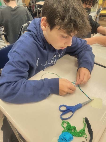 Seventh grade student making Friendship Bracelet